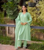 girl wearing pastel green mid season linen dress